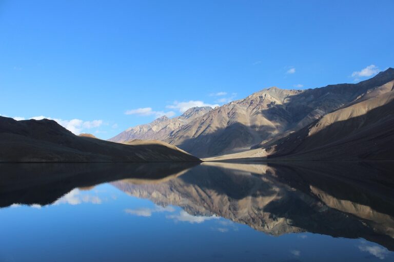 Discover Himachal Manali taxi service for Manali, Spiti & Ladakh tours." Crystal-clear waters of Chandratal Lake reflecting the majestic Himalayan peaks.